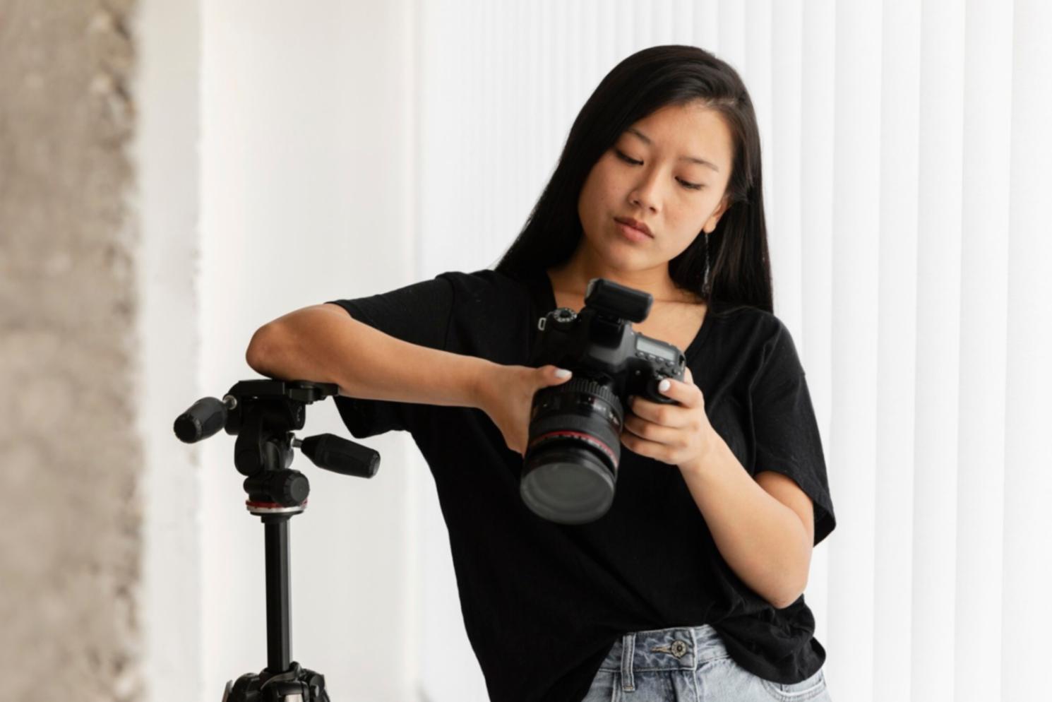 Student reviewing video editing feedback on laptop screen showing timeline with instructor notes